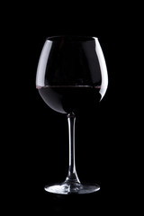 elegant galss of red wine on black background