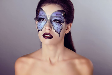 Fashion Make up. Butterfly makeup on face beautiful woman. Art P
