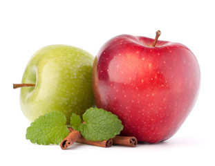 Red and green apples, cinnamon sticks and mint leaves still life