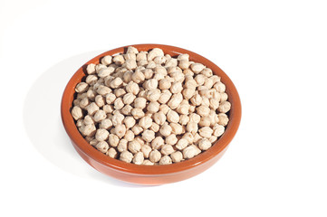 clay bowl filled with chickpeas, isolated on white background