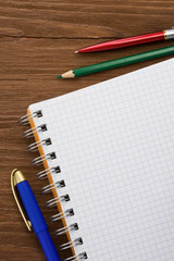 checked notepad and pen on wood