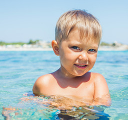 Young boy swimming in sea