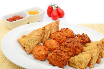 Indian snack selection and tomatoes