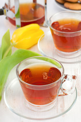 two cups of tea with flower