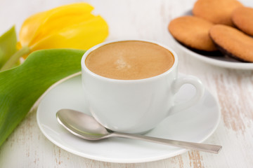 cup of coffee, cookies and yellow tulip