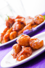 Four fritters in a small plate.