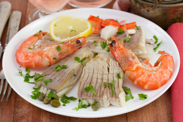 fish ray with seafood, capers and lemon on the plate