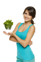 Light food concept. Smiling woman balancing lettuce