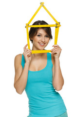 Happy woman looking through the house frame