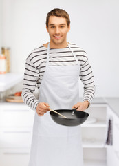 handsome man with pan at kitchen