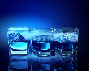 Three glasses of blue liquid