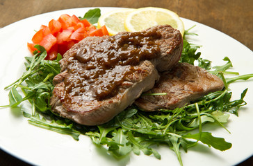 meat table : roast beef fillet with vegetables served on white p