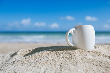 white espresso coffee cup with ocean , beach and seascape