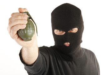Masked man bomber aims with hand grenade