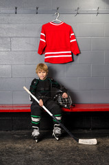 Naklejka premium Young Boy in Hockey Dressing Room