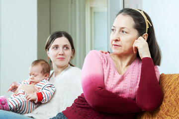 Adult daughter with baby asks for forgiveness from  mother