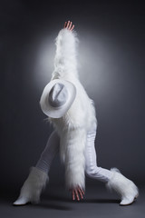 Sexy striptease dancer in white fur costume