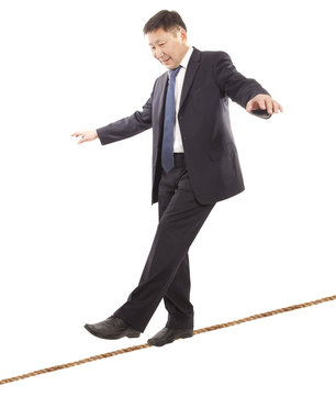 Asian businessman rope-walker