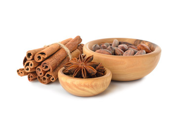 Cinnamon, anise and cocoa beans in a wooden bowl