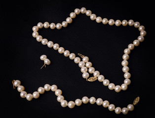 Pearl necklace on black background