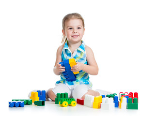 little cheerful child with construction set over white backgroun