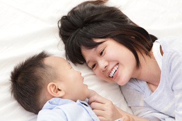 Mother and son smile and look each other