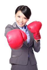 business woman punching by boxing gloves