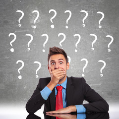 business man looking shoked by all the questions