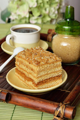 Cake with coffee on a wooden tray