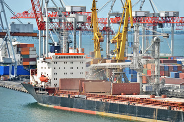 Container stack and ship under crane bridge