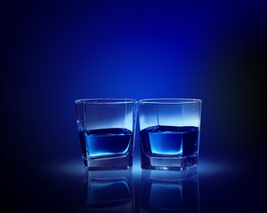 Two glasses of blue liquid