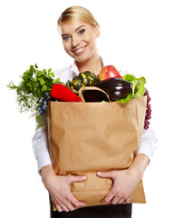 beautiful young woman with vegetables and fruits in shopping bag