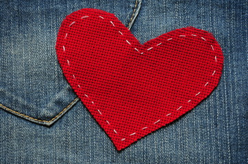 Jeans background with red heart