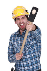 An angry construction worker with a sledgehammer.