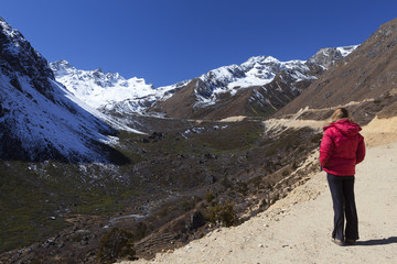 Naklejka na ściany i meble Woman enjoying view of Tsopta Valley, North Sikkim.
