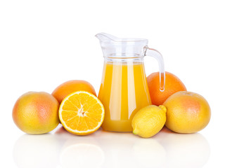 Jug of orange juice and citrus fruits isolated on white