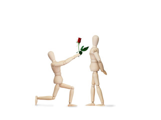 Wooden model handing over love gift to friend on Valentine day