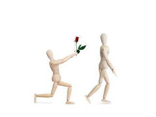 Wooden model handing over love rose to friend on Valentine day