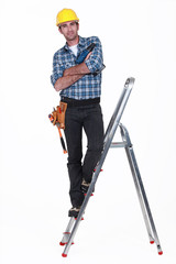 Tradesman standing on the steps of a stepladder