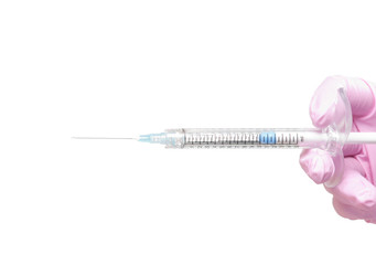 Close-up image of a medical syringe held in a hand