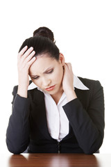 Sad businesswoman sitting behind the desk