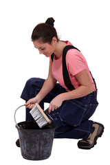 Woman kneeling by bucket