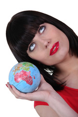 Smart woman with globe in hand