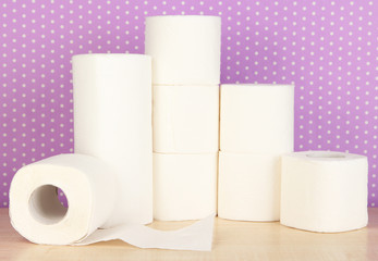 Rolls of toilet paper on purple with dots background