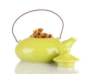 Dried herbs in teapot, isolated
