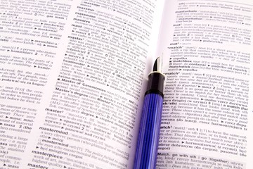 Dictionary and a blue ink pen