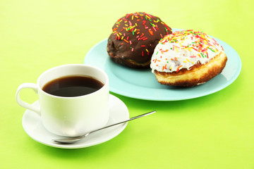 Tasty donuts on color plate on color background