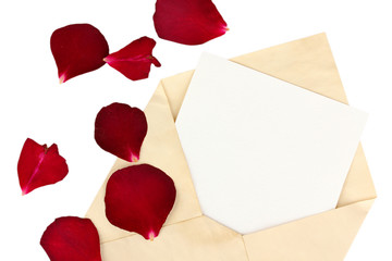 Old envelope with blank paper and dried rose petals isolated