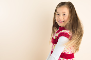 Happy Young Girl with Flowing Hair, wearing Knitted Dress