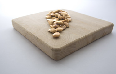 Fried almonds over wooden board